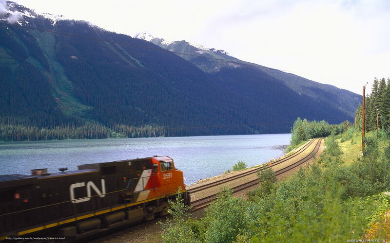 Train by a mountain lake