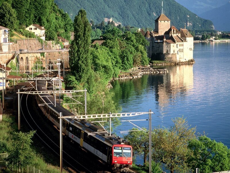 Train by lake with castle
