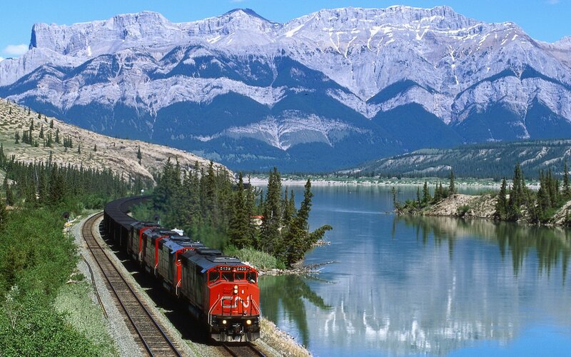 Train by mountain lake