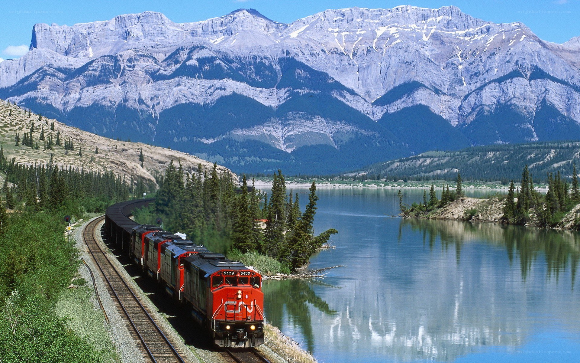 Train by mountain lake