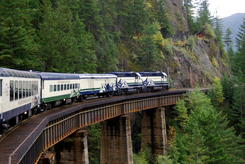 Train crossing a forest bridge