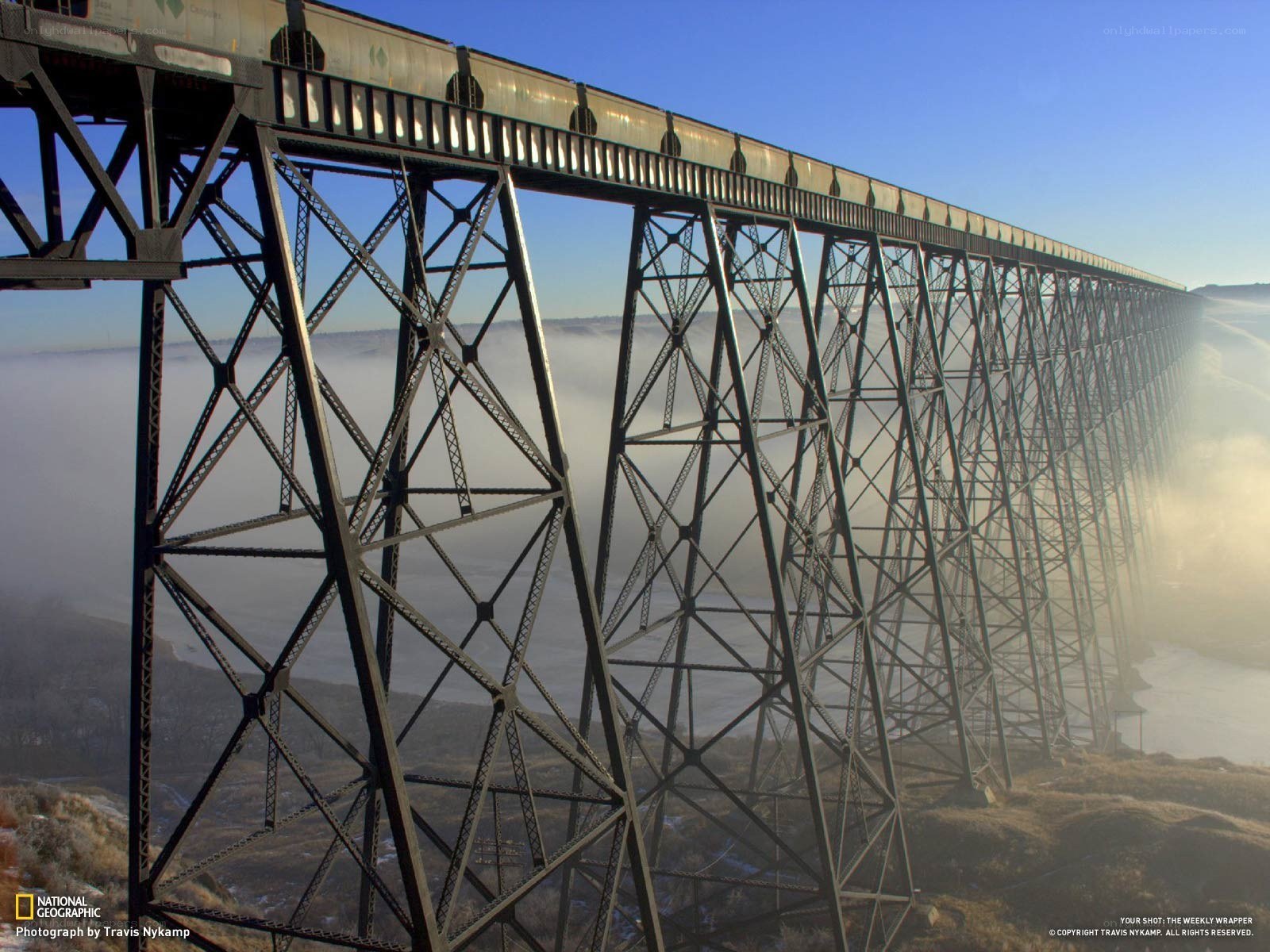 Train crossing a high trestle bridge