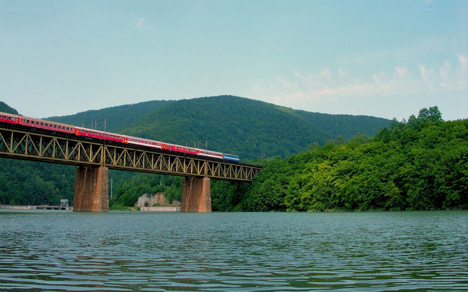 Train crossing a river bridge