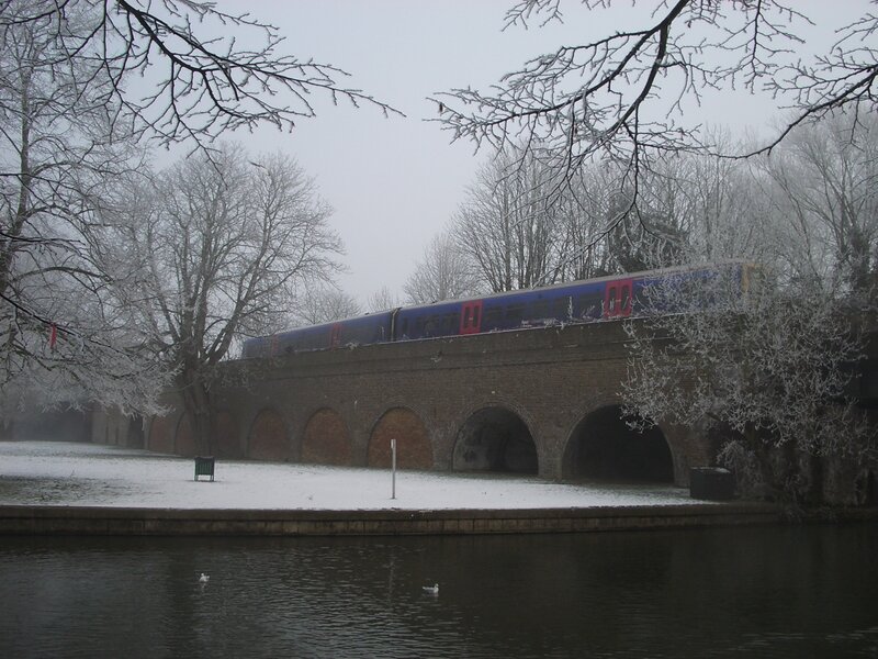Train crossing a snowy bridge