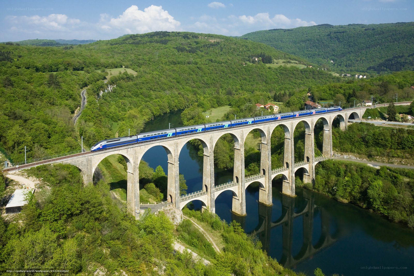 Train crossing a stone viaduct