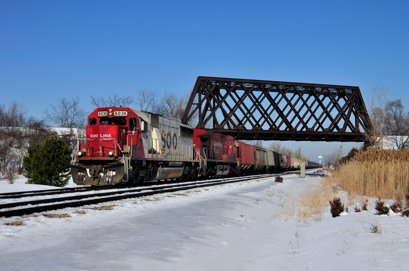 Train crossing bridge in winter