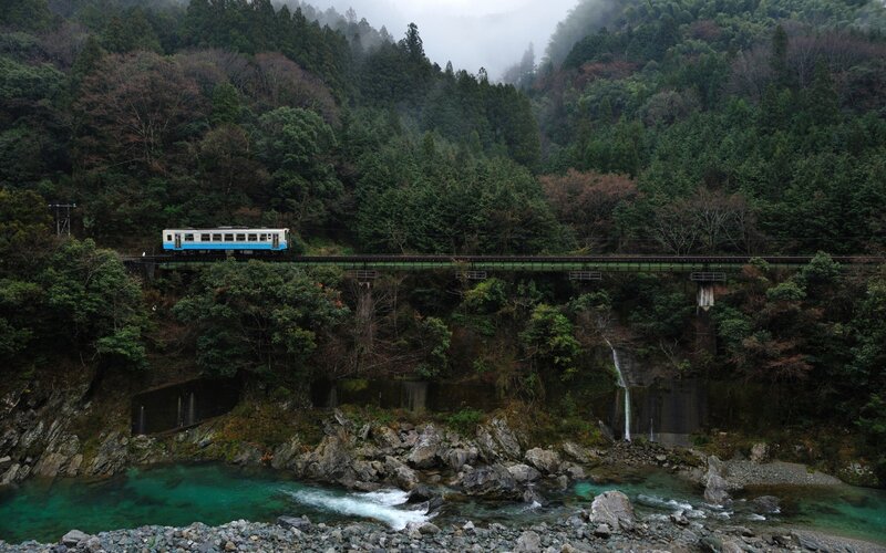 Train crossing bridge over river