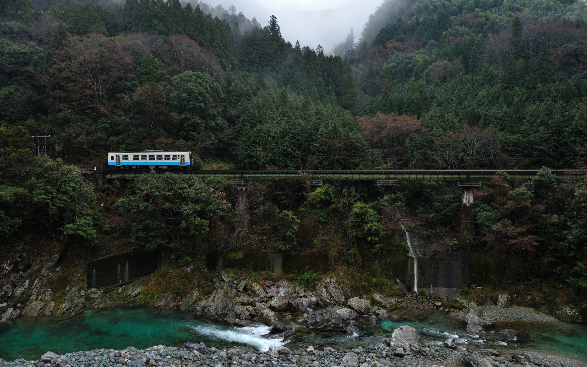 Train crossing bridge over river