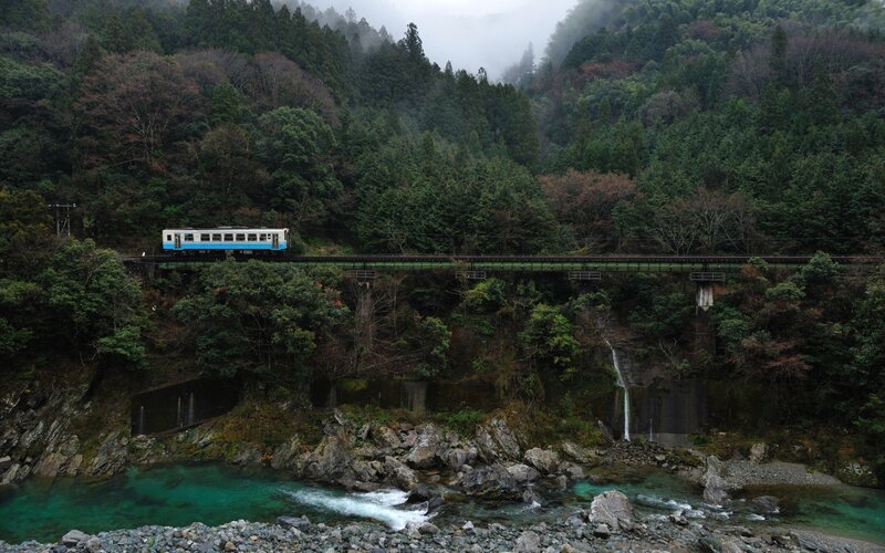 Train crossing bridge over river