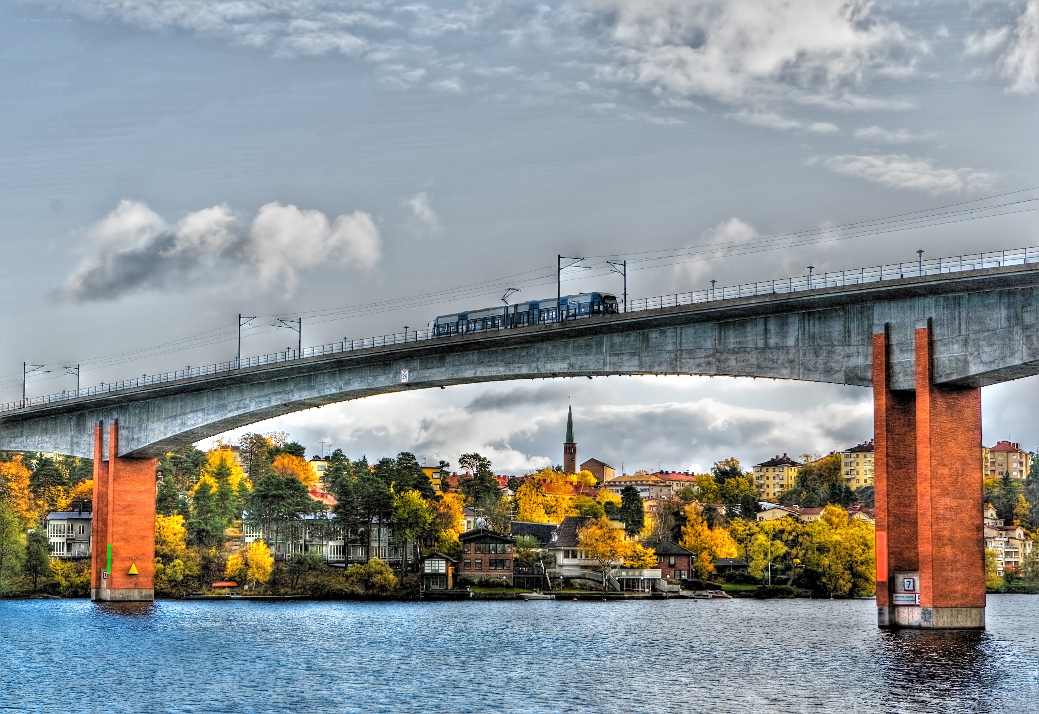 Train crossing bridge over water