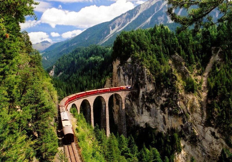 Train crossing mountain bridge