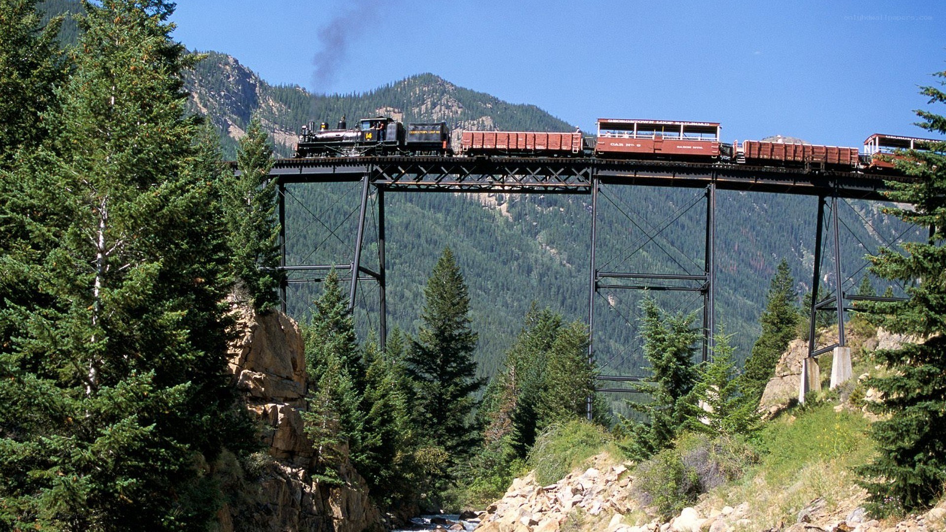 Train crossing mountain bridge