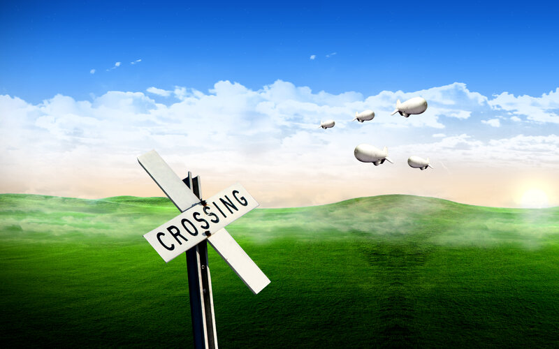 Train crossing sign with blimps
