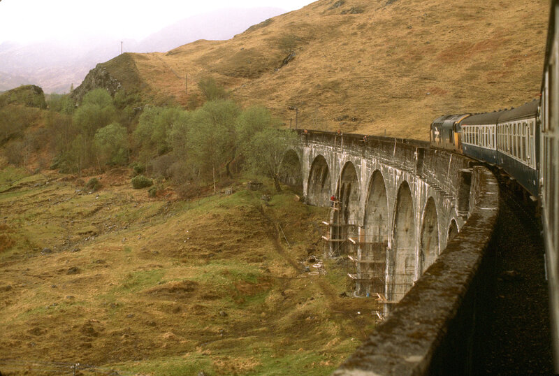 Train crossing viaduct in Scottish Highlands