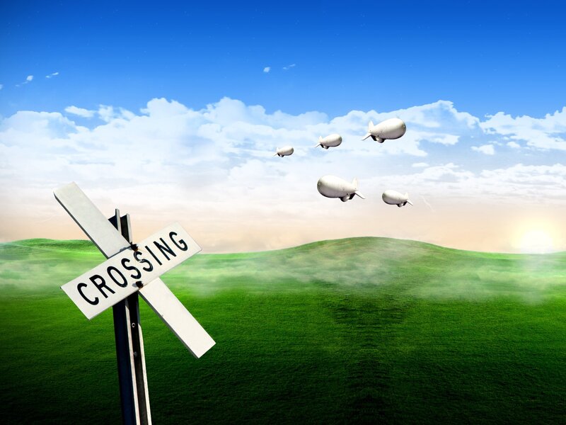 Train crossing with blimps