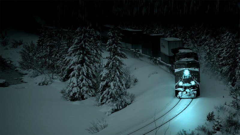 Train in snowy forest at night