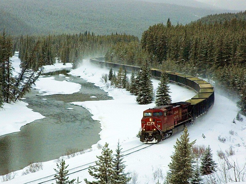 Train in snowy forest landscape