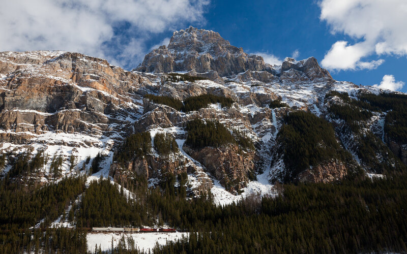 Train in snowy mountain valley