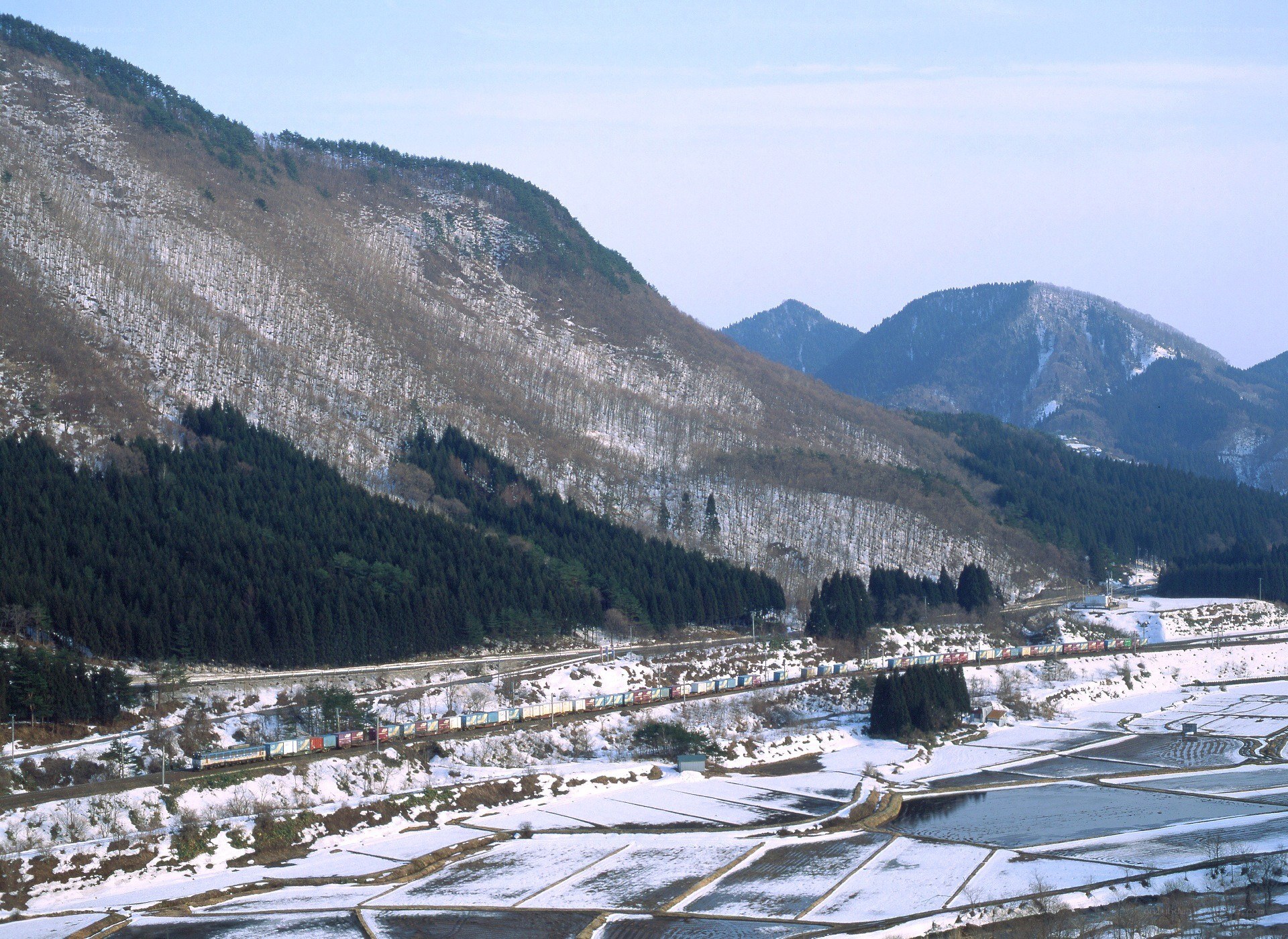 Train in snowy mountain valley