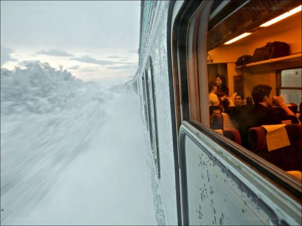 Train journey through snowy landscape