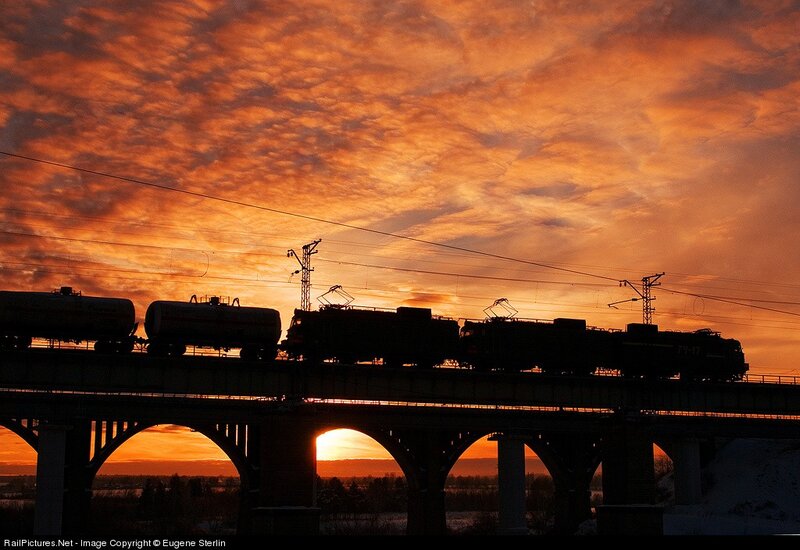 Train on bridge at sunset