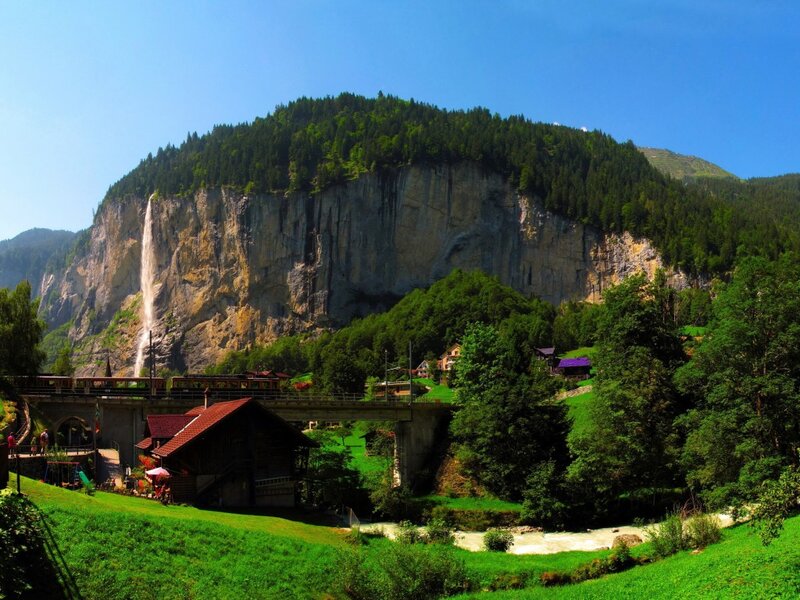 Train on Bridge Near Waterfall