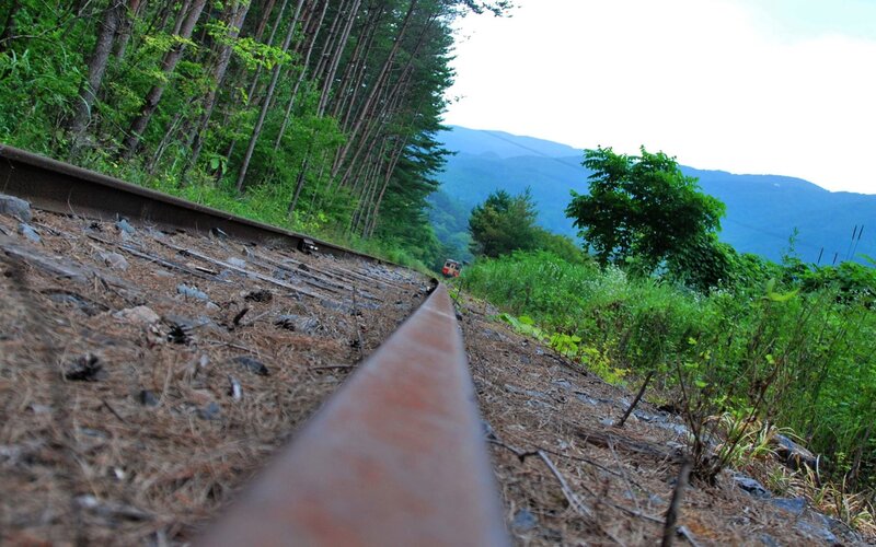 Train on Mountain Track — Green, Serene, Afternoon, Photograph, Railway Tracks