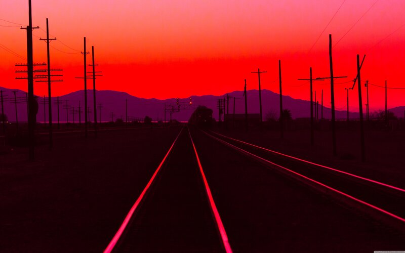 Train on Tracks at Sunset — Red