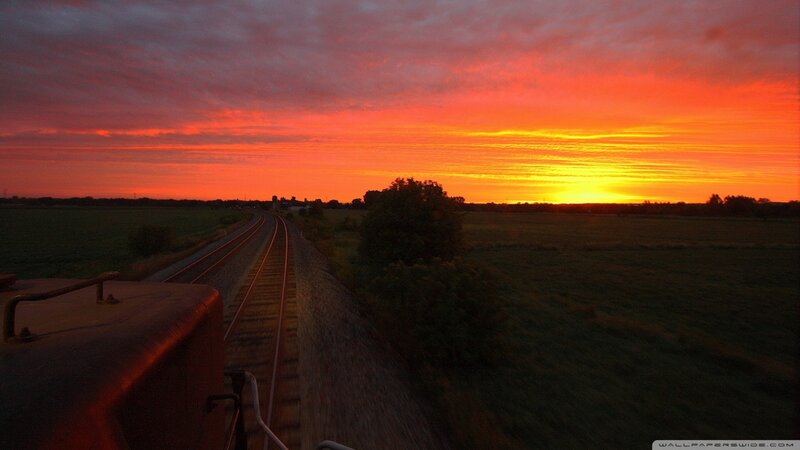 Train on Tracks at Sunset