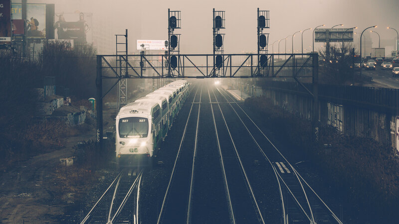 Train on tracks in foggy city