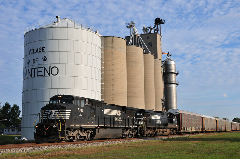 Train passing grain silos