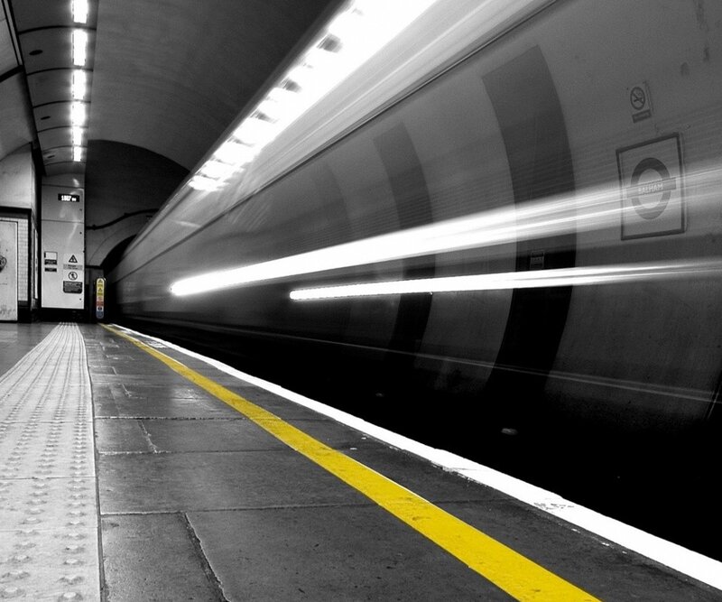 Train speeding through subway station