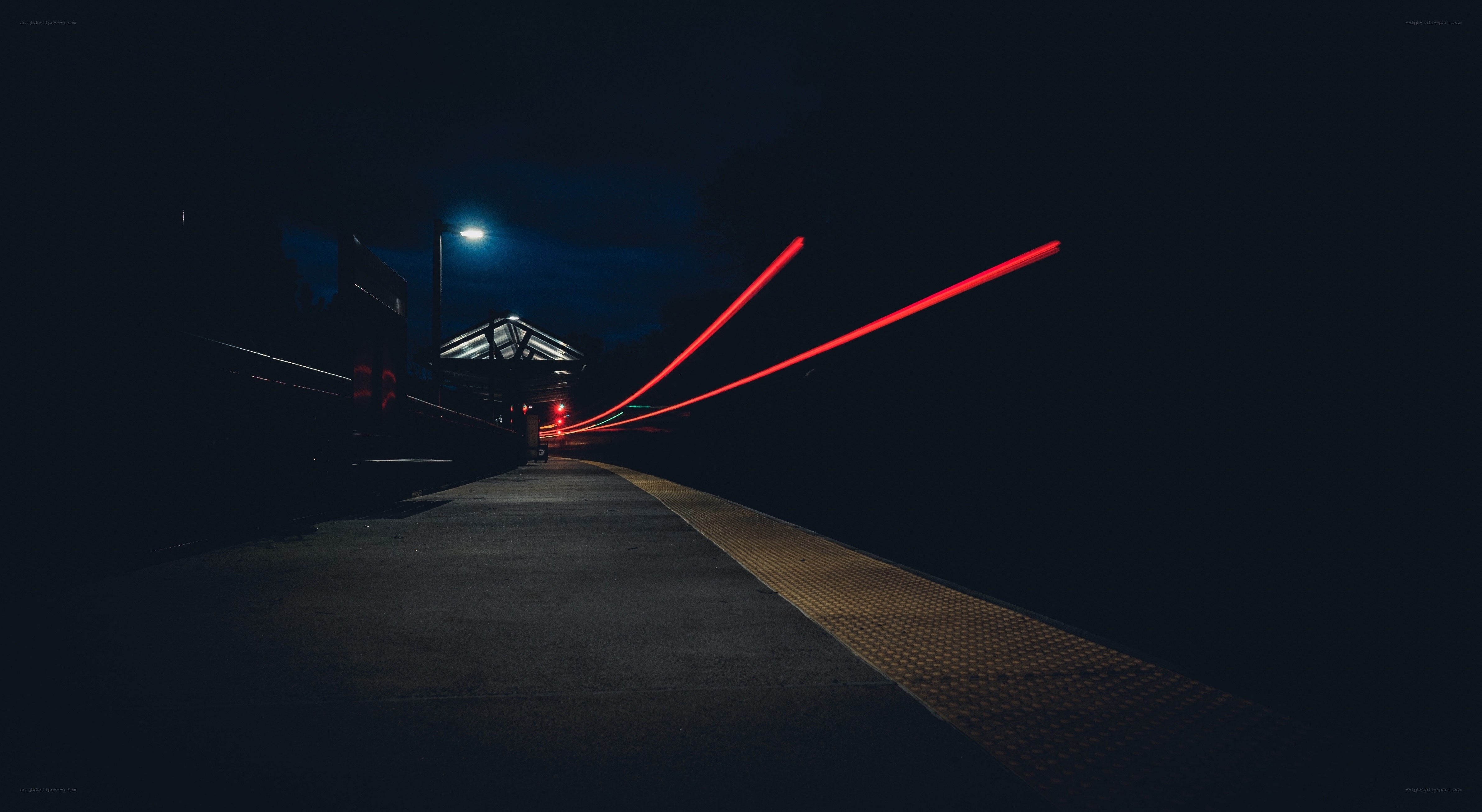 Train station at night with light trails