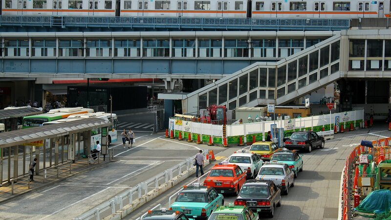 Train station with taxis and buses