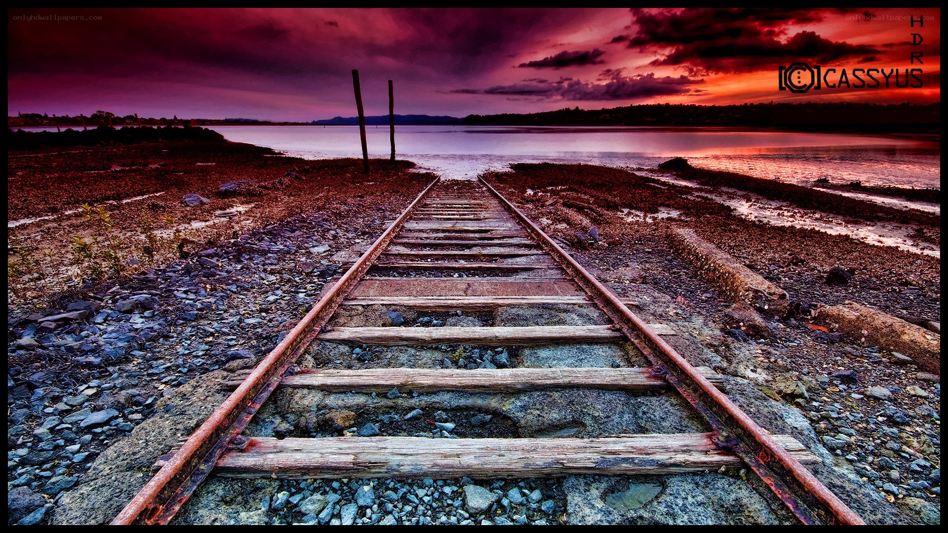 Train tracks at sunset by the water
