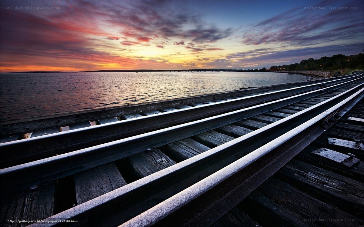 Train tracks at sunset by the water