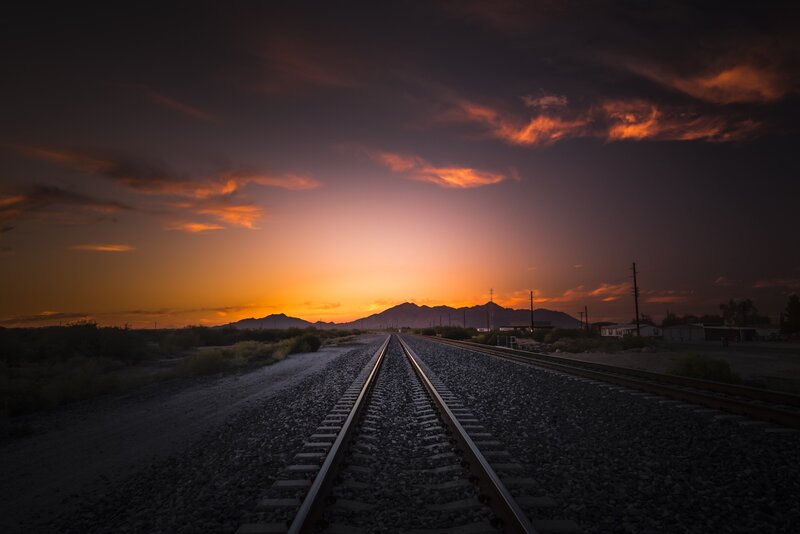 Train Tracks at Sunset — Orange, Dramatic, Photograph, Mountains