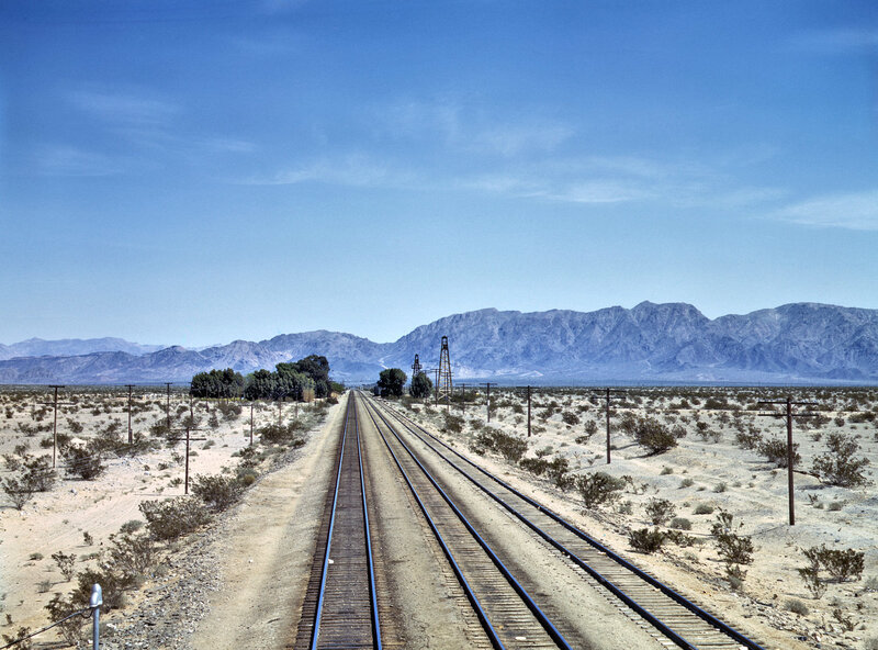 Train tracks in desert landscape
