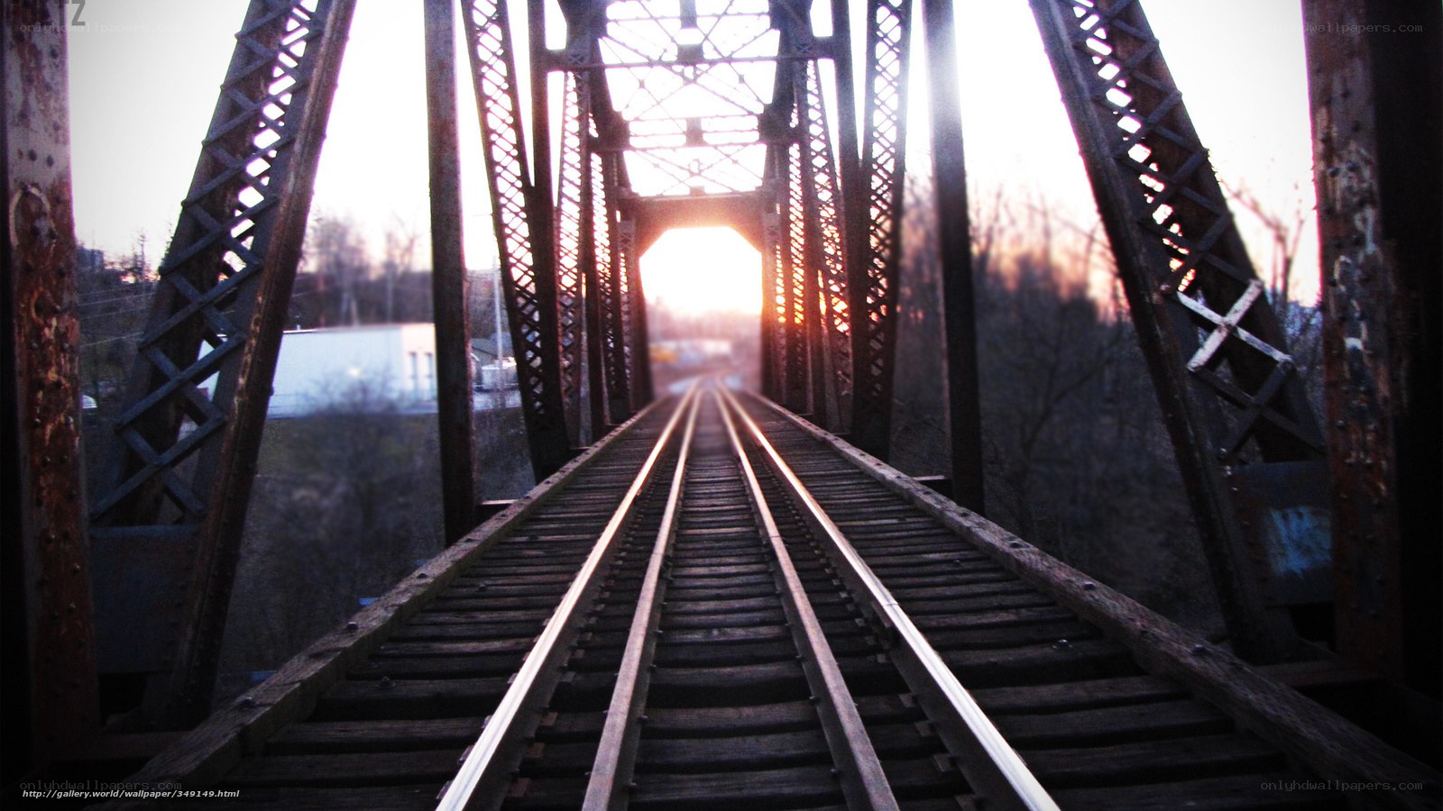 Train tracks on a bridge at sunset