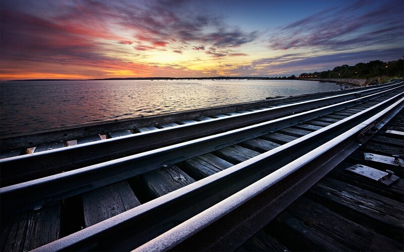 Train Tracks on Pier — Orange, Dramatic
