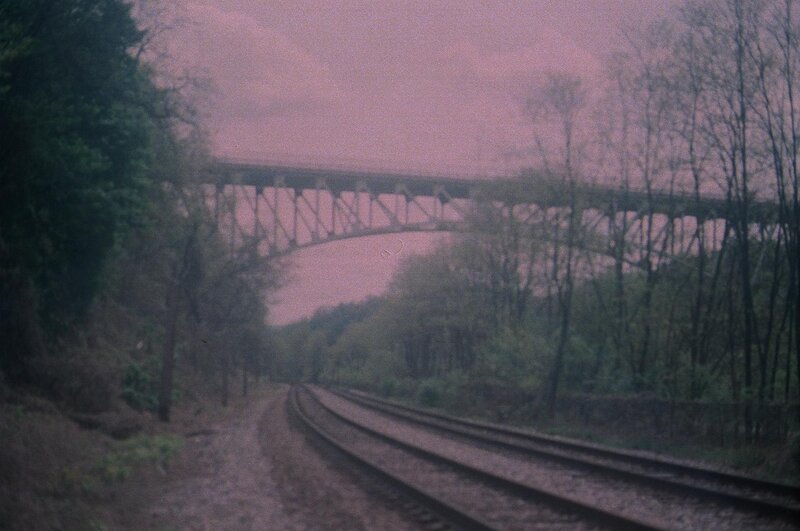 Train tracks under a bridge