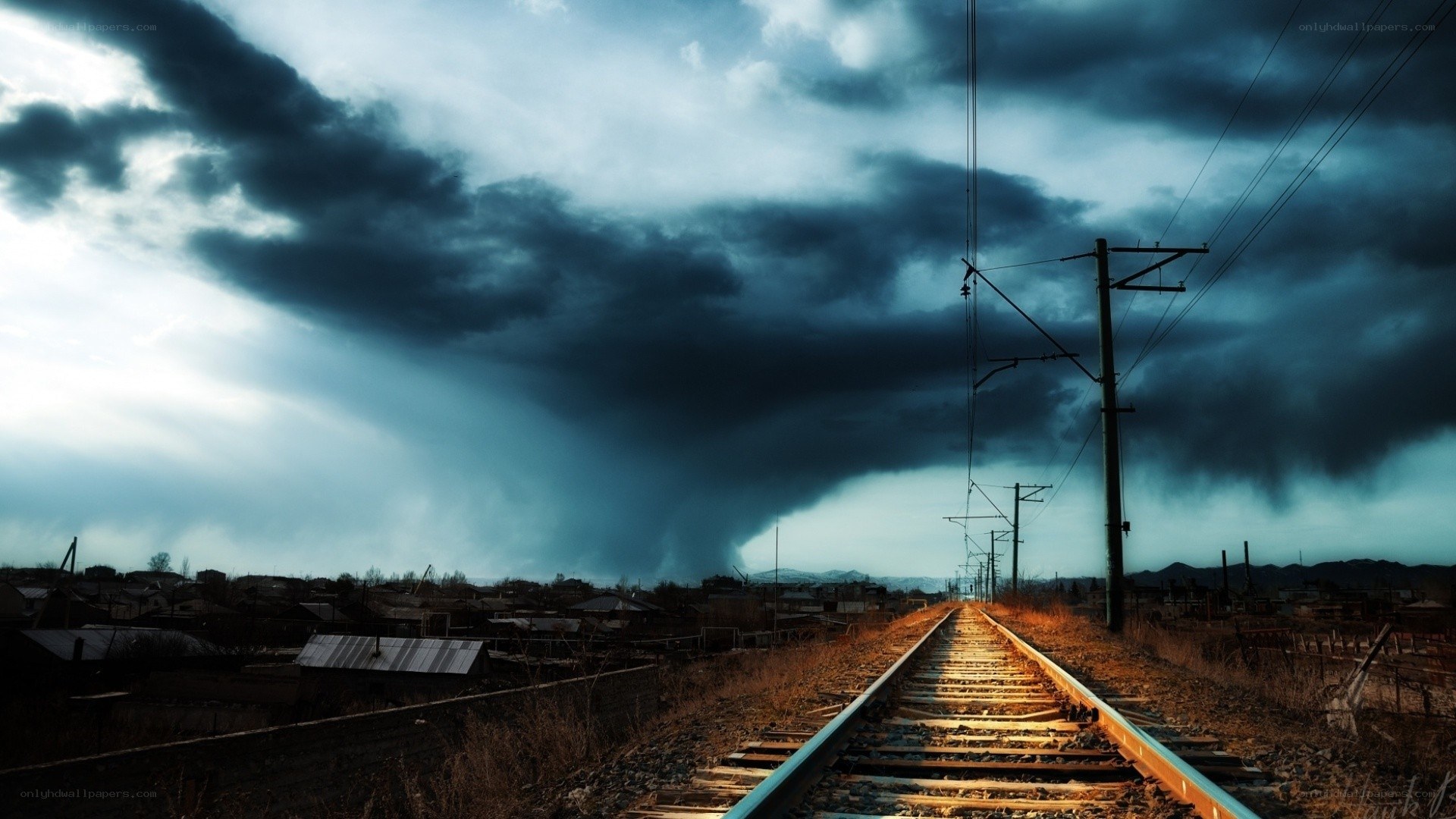 Train tracks under stormy sky