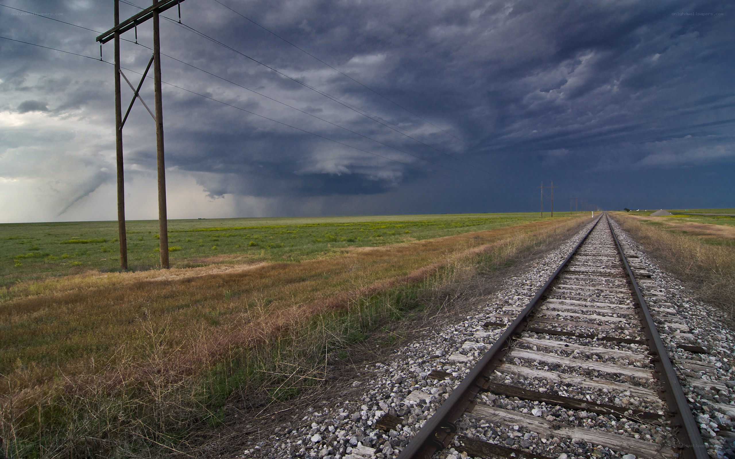 Train tracks under stormy sky