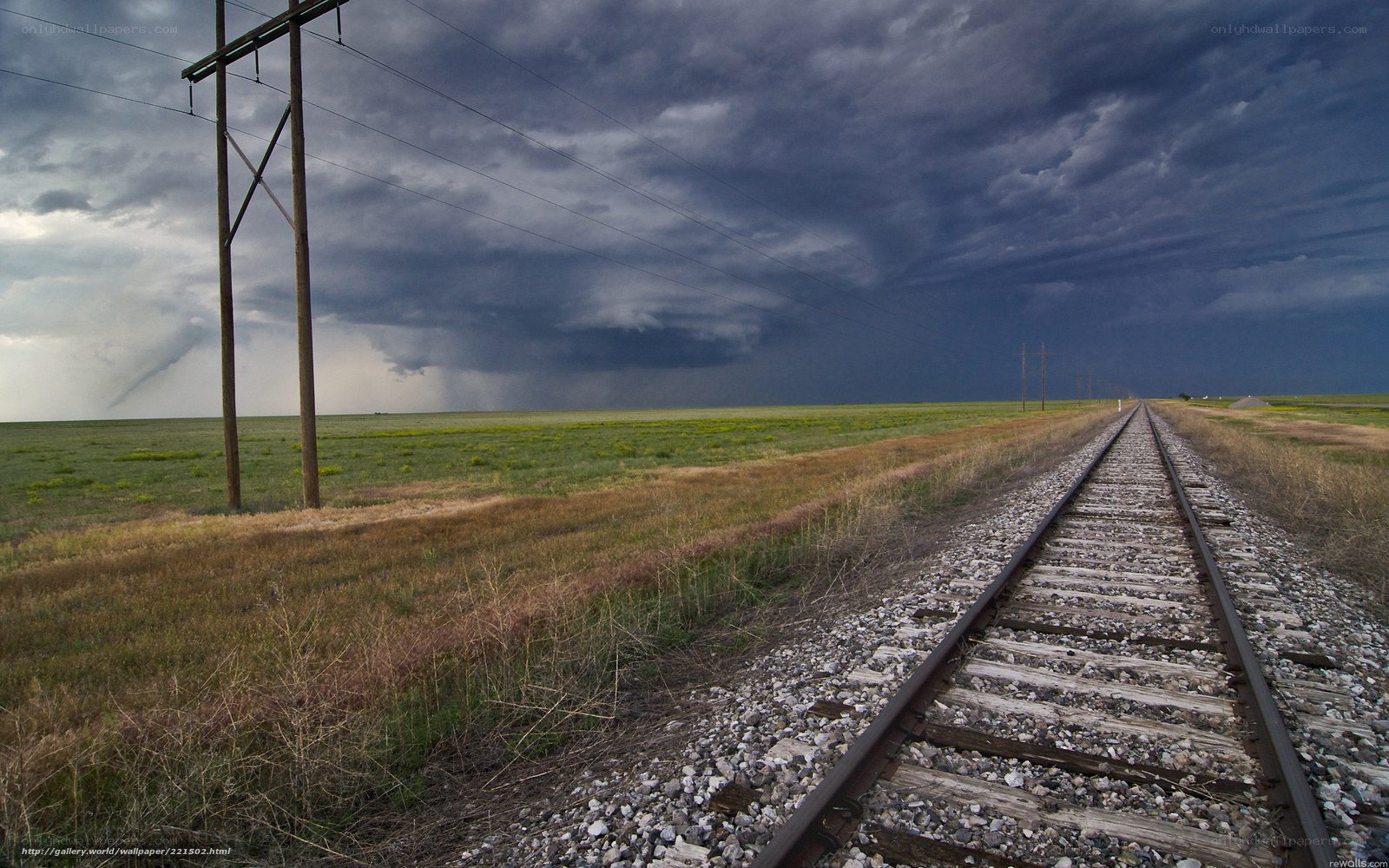 Train tracks under stormy sky