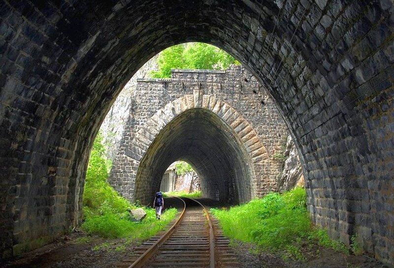Train tunnel with hiker