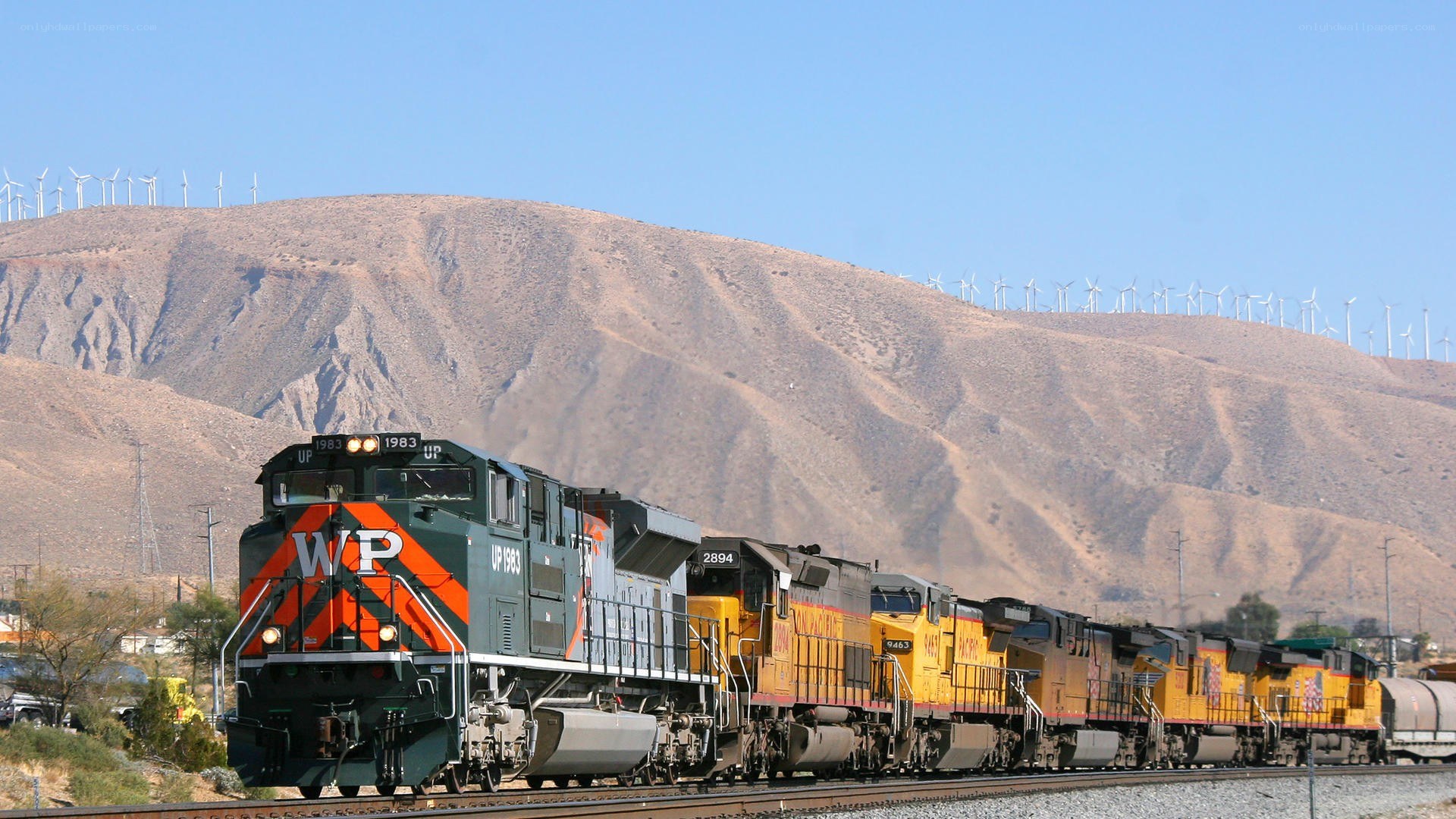 Train with wind turbines in background