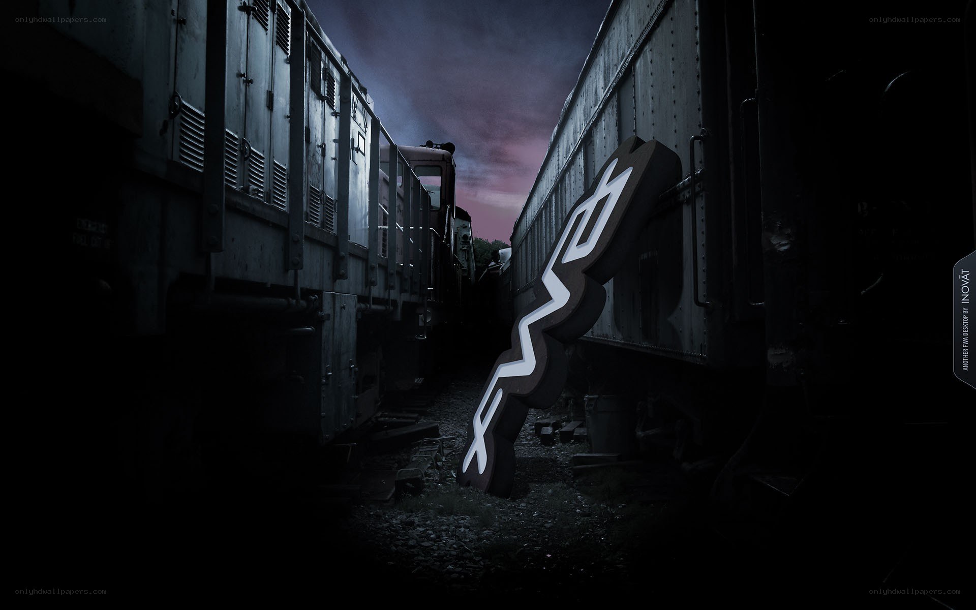 Train yard at dusk with logo