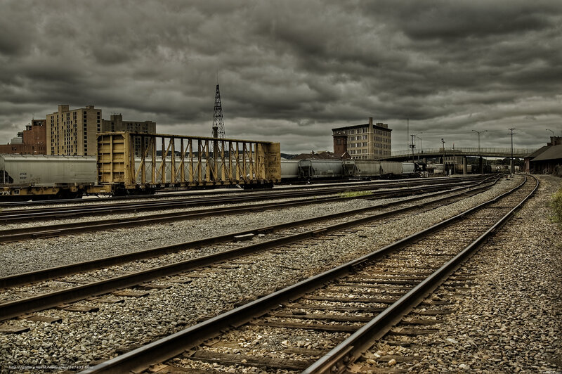 Train yard under stormy sky