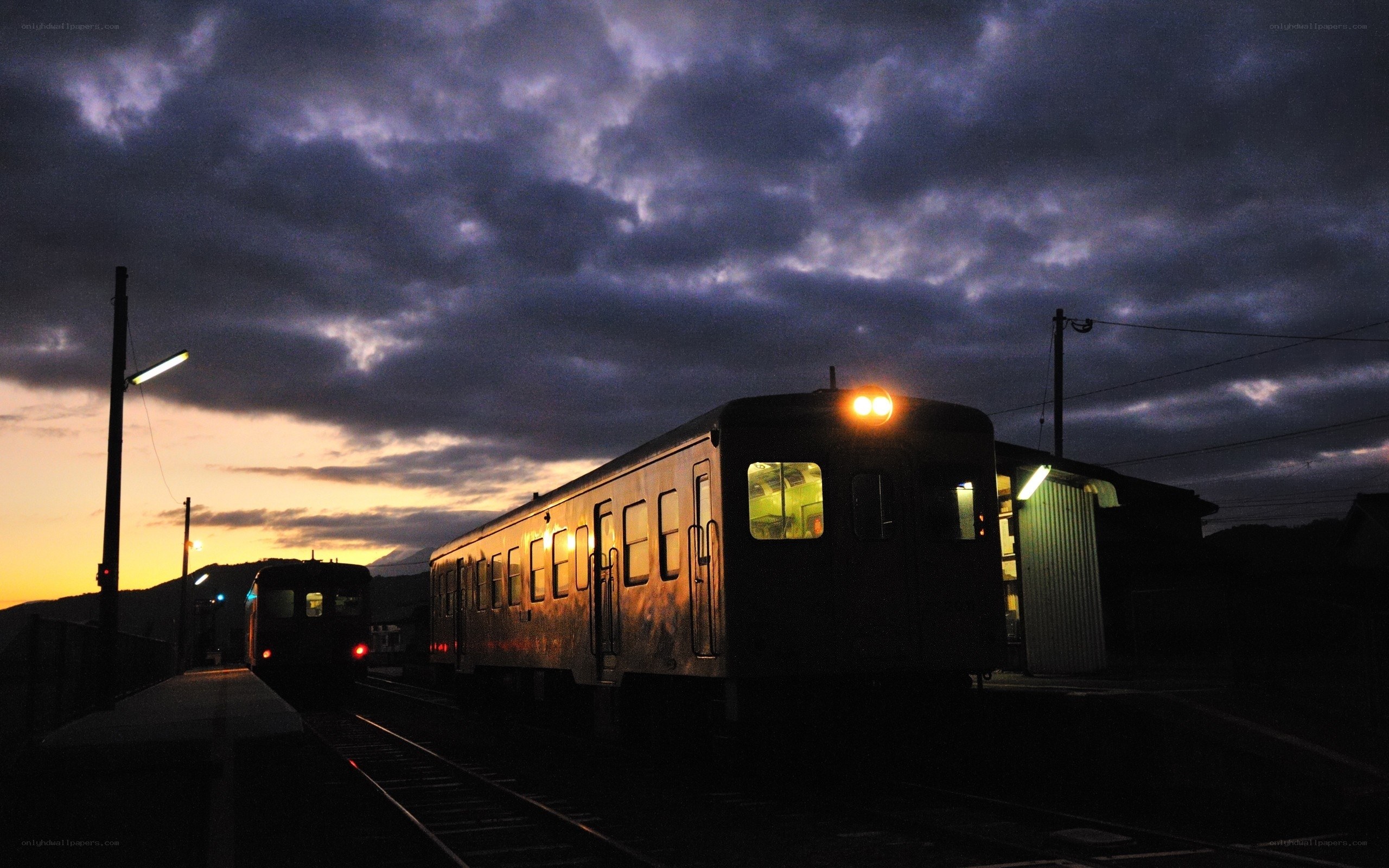 Trains at a station at dusk