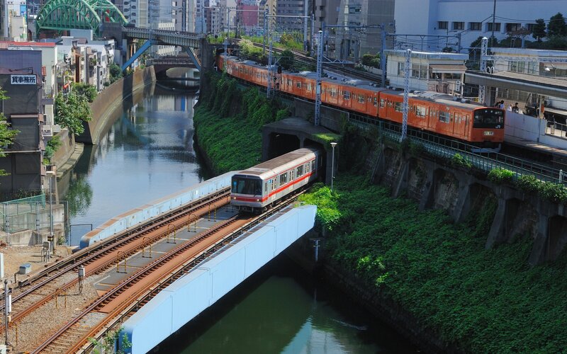 Trains crossing a canal in Japan
